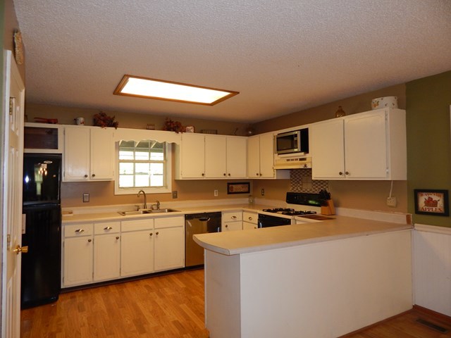 826 McKay Road Gray, GA 31032 - Photo 10 of 28 a kitchen with a sink a stove cabinets and a window