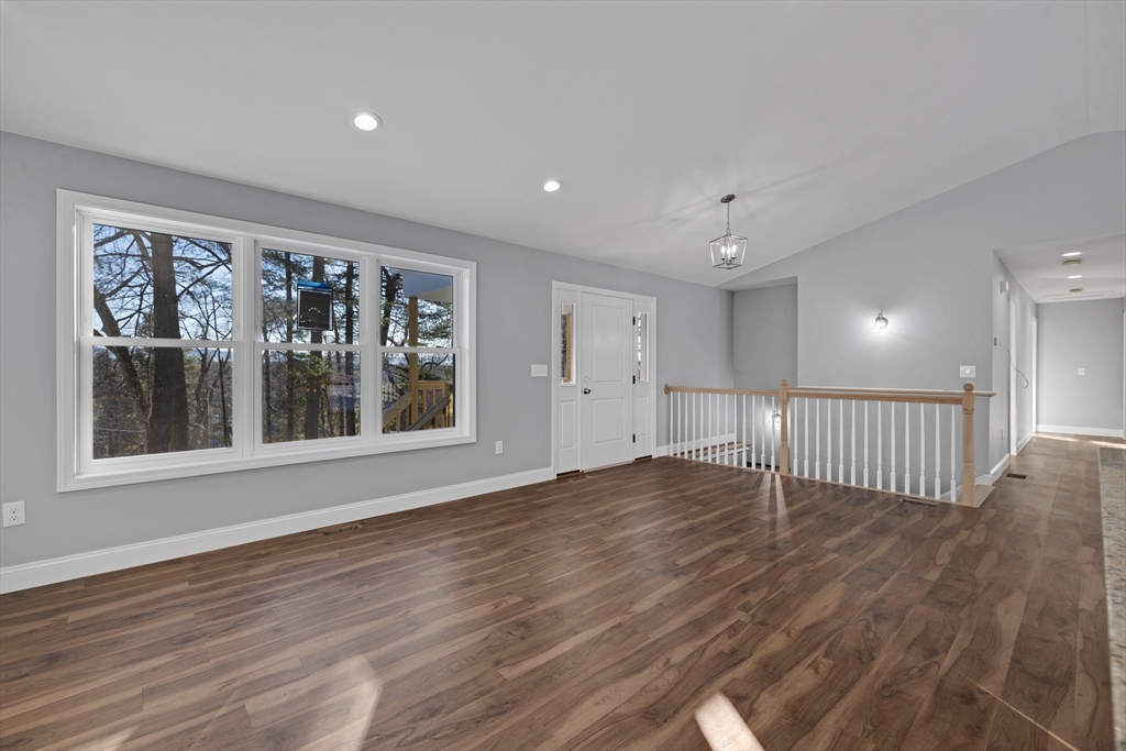 132 Kibbe Road East Longmeadow, MA 01028 - Photo 9 of 32 a view of an empty room with wooden floor and a window
