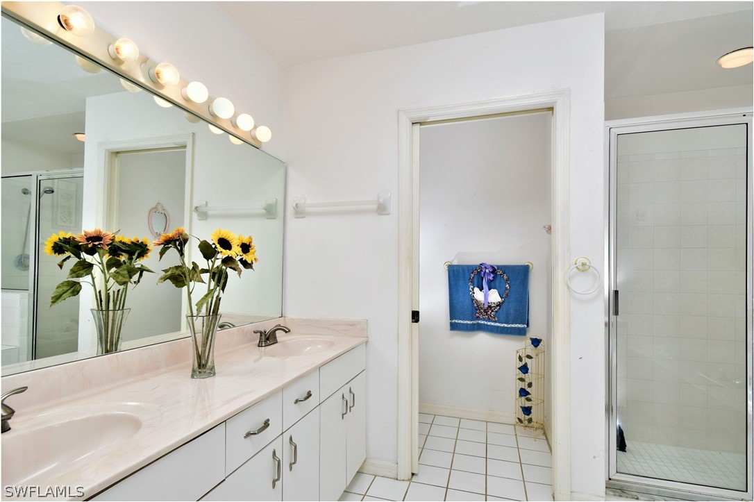 517 Marby Road Lehigh Acres, FL 33936 - Photo 14 of 29 a bathroom with a sink and a mirror