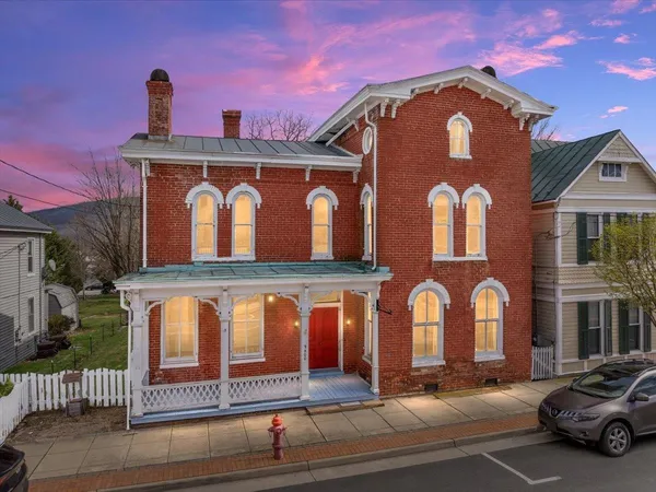 a view of a brick house with large windows