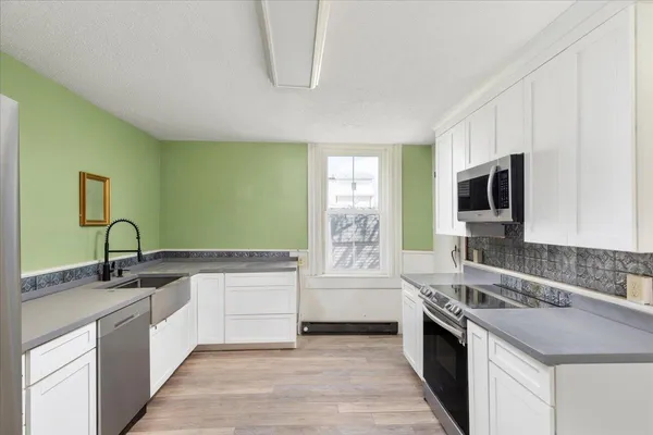 a kitchen with a sink and cabinets