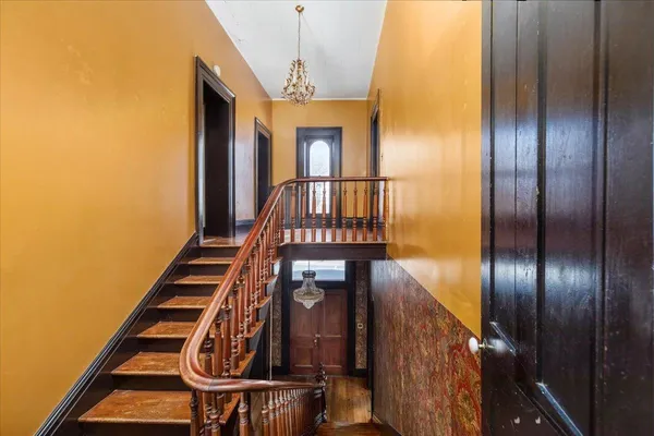 a bathroom with a granite countertop toilet sink and mirror