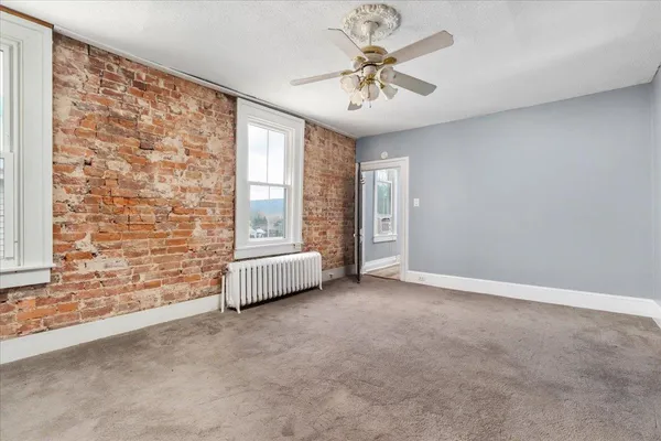 a view of a livingroom with wooden floor and a window