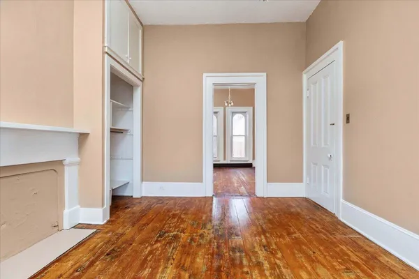 a bed room with a bed window and a mirror