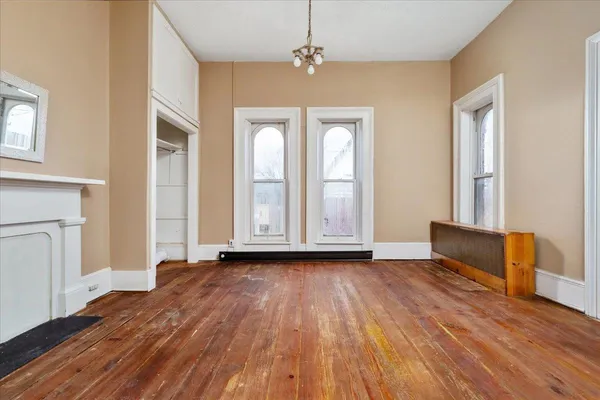 a view of a room with wooden floor and iron stairs