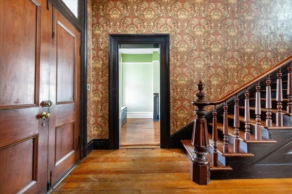 a view of entryway with wooden floor and a window