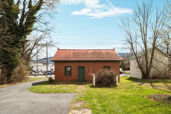 an aerial view of residential houses with outdoor space and swimming pool