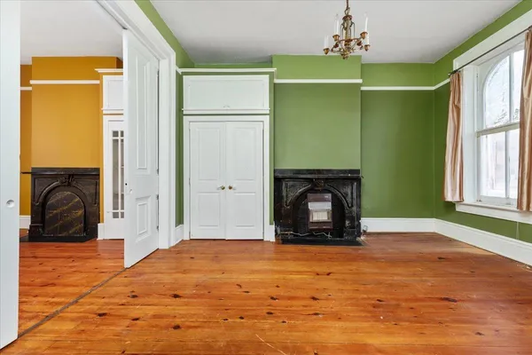 a bedroom with a bed dresser and a window
