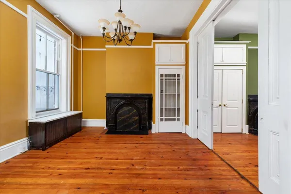 a view of a livingroom with a fireplace and windows