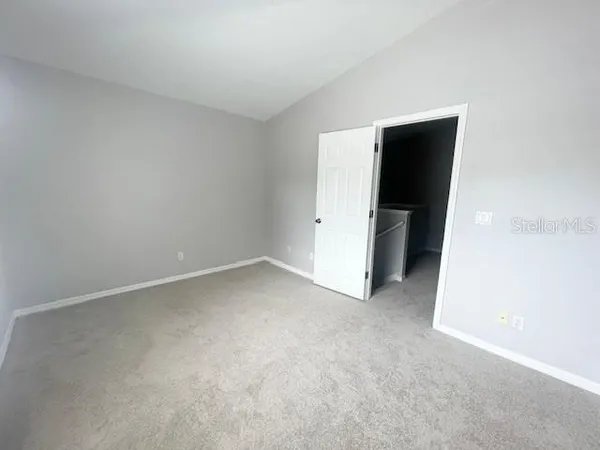 a view of an empty room with closet