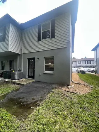 a backyard of a house with table and chairs