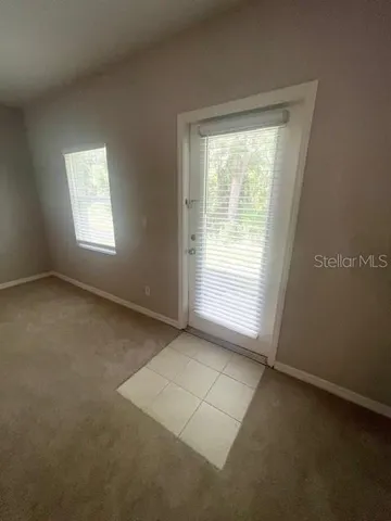 an empty room with a empty space and windows