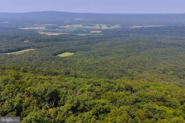 an aerial view of residential house and green space