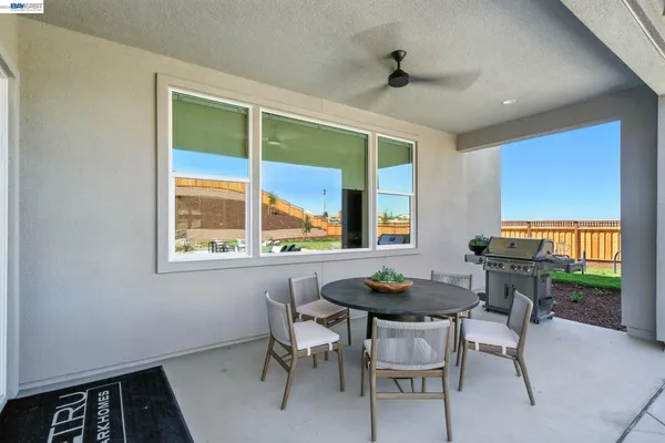 a living room with furniture a rug and a large window
