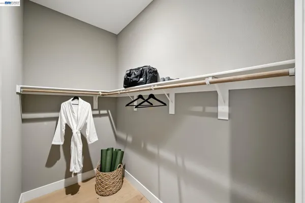 a bathroom with a sink a toilet a mirror and shower