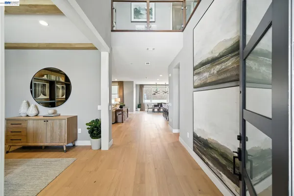 a view of a living room and entryway with furniture