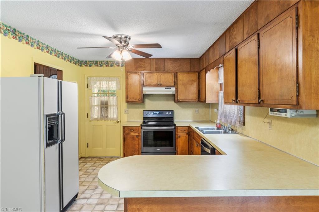 1015 Meadowview Road Walnut Cove, NC 27052 - Photo 11 of 27 Kitchen with side by side refrigerator, slide in range/oven, dishwasher
