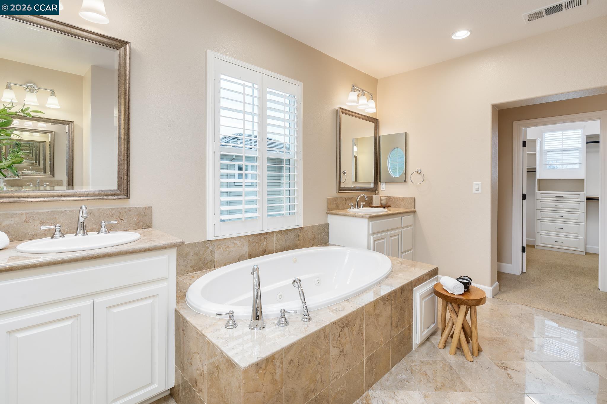5058 Holborn Way San Ramon, CA 94582 - Photo 20 of 46 a bathroom with a tub sink and mirror