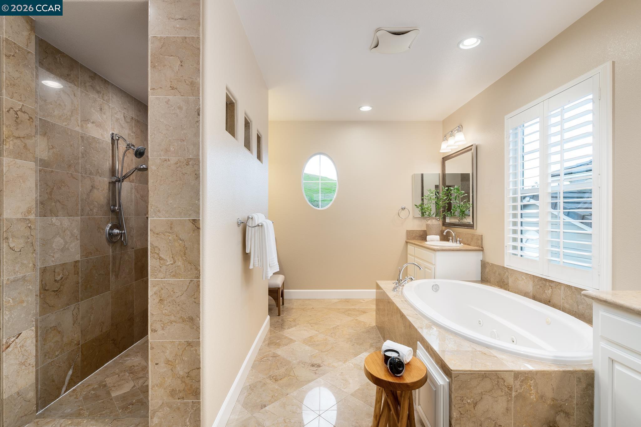 5058 Holborn Way San Ramon, CA 94582 - Photo 21 of 46 a bathroom with a tub sink and mirror