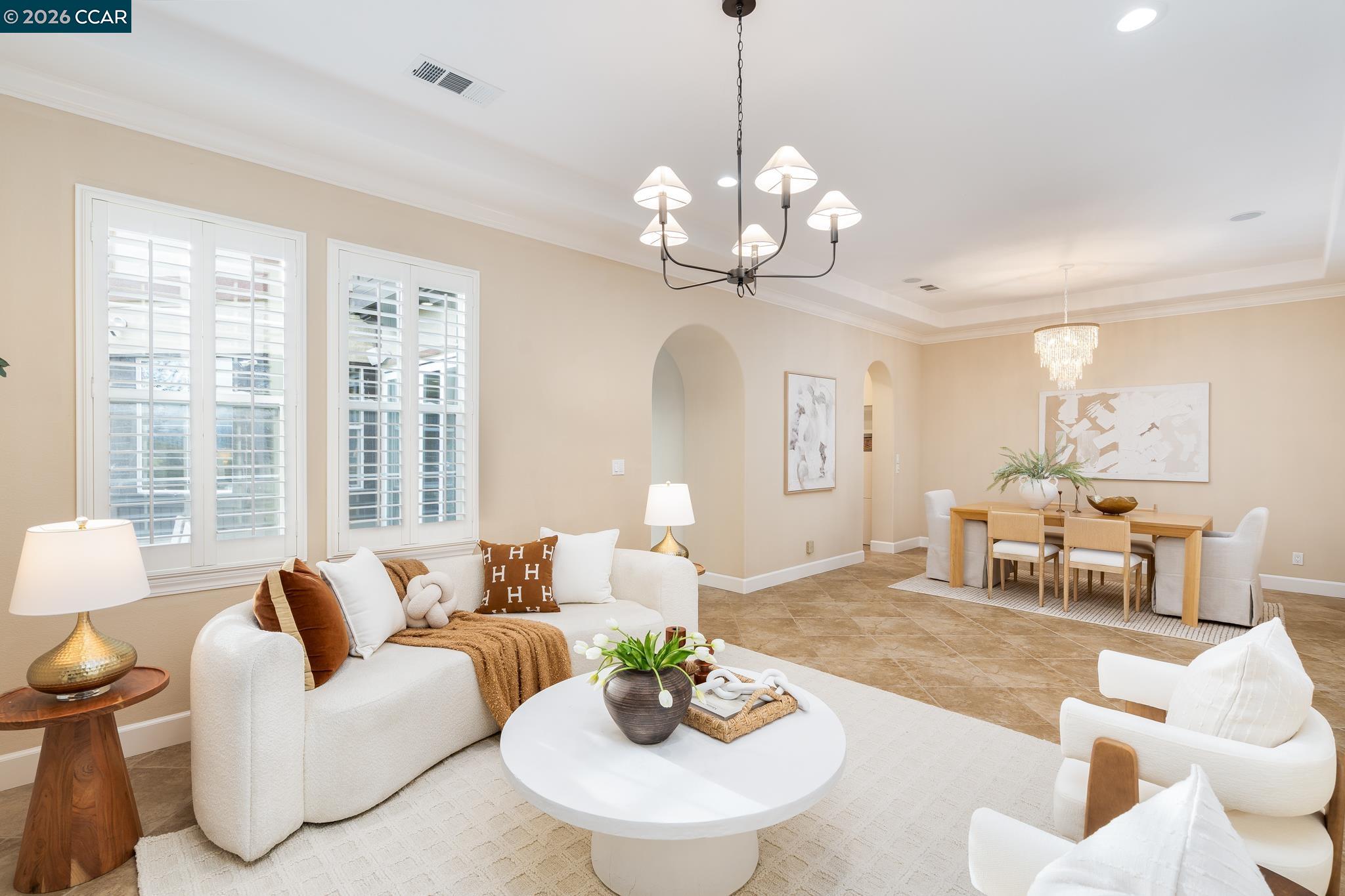 5058 Holborn Way San Ramon, CA 94582 - Photo 4 of 46 a living room with couches a dining table and a chandelier