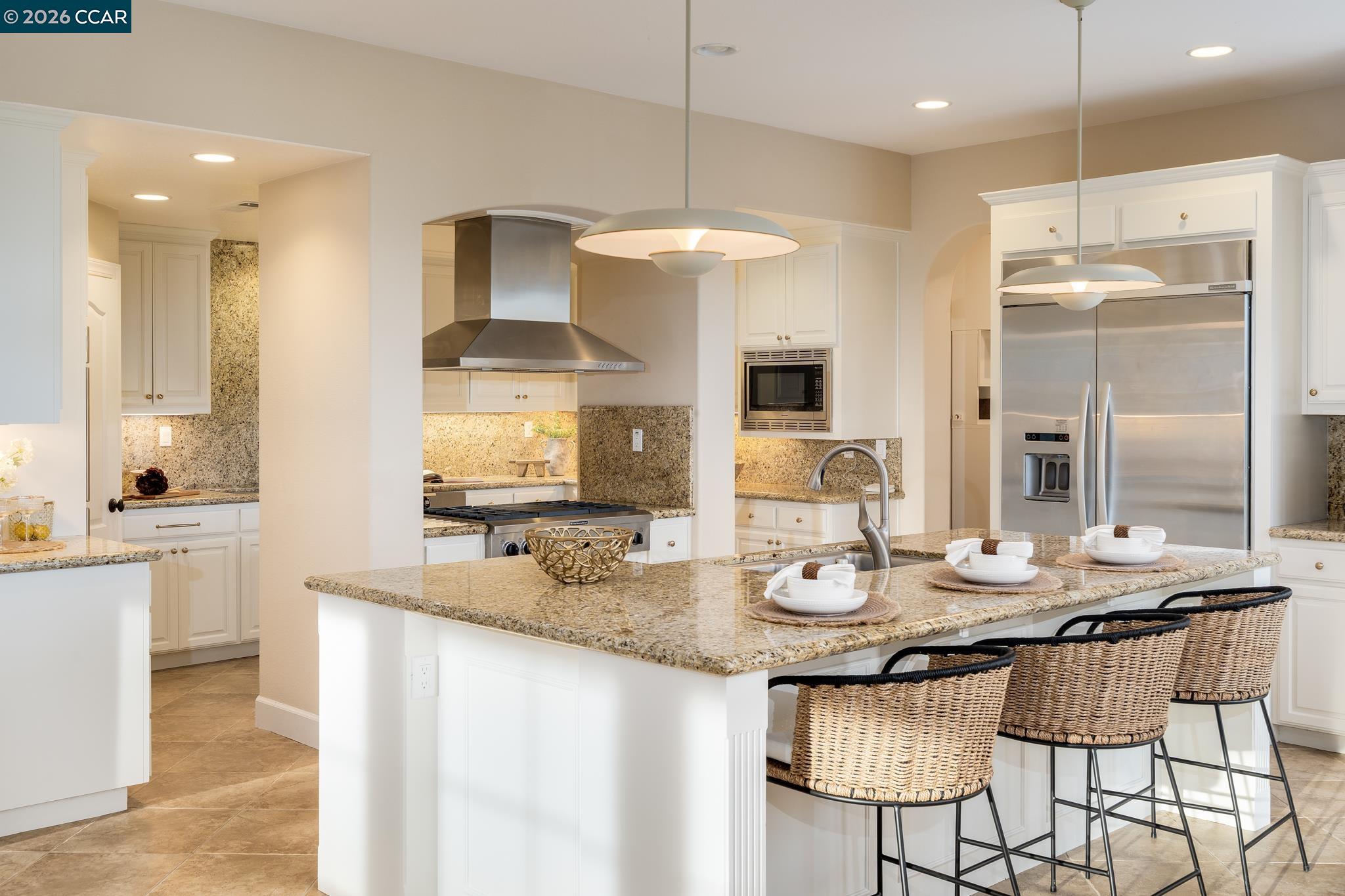 5058 Holborn Way San Ramon, CA 94582 - Photo 41 of 46 a kitchen with kitchen island granite countertop a sink and a refrigerator