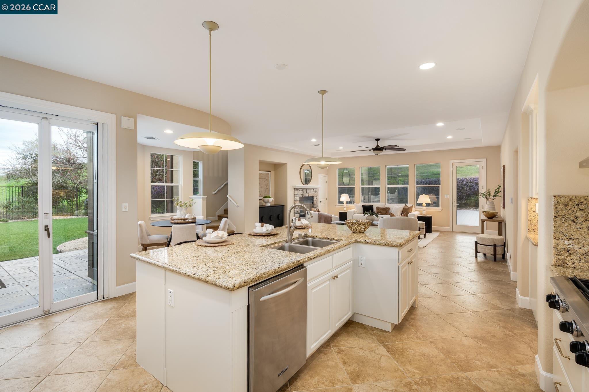 5058 Holborn Way San Ramon, CA 94582 - Photo 44 of 46 a open kitchen with kitchen island a sink table and chairs