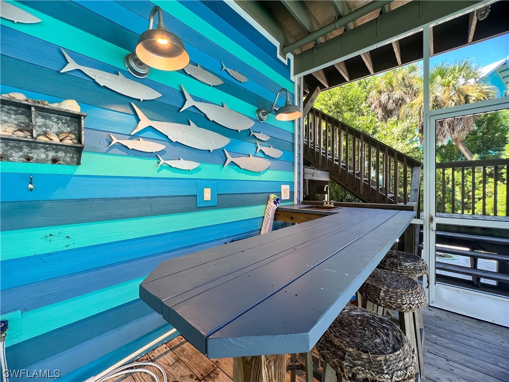 4510 Schooner Drive Upper Captiva, FL 33924 - Photo 13 of 48 a room with wooden floor and windows