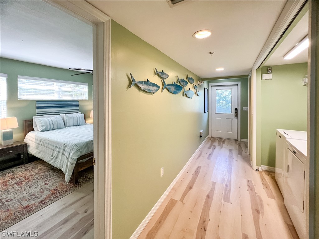 4510 Schooner Drive Upper Captiva, FL 33924 - Photo 24 of 48 a bedroom with a bed and wooden floor