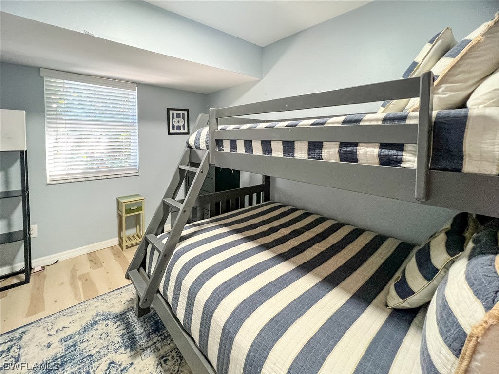 4510 Schooner Drive Upper Captiva, FL 33924 - Photo 30 of 48 a bed sitting in a bedroom next to a window