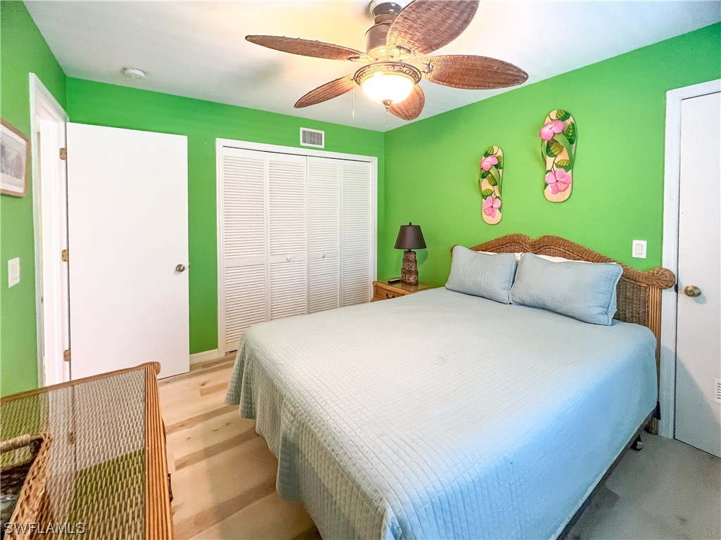 4510 Schooner Drive Upper Captiva, FL 33924 - Photo 37 of 48 a bedroom with a bed and a chandelier