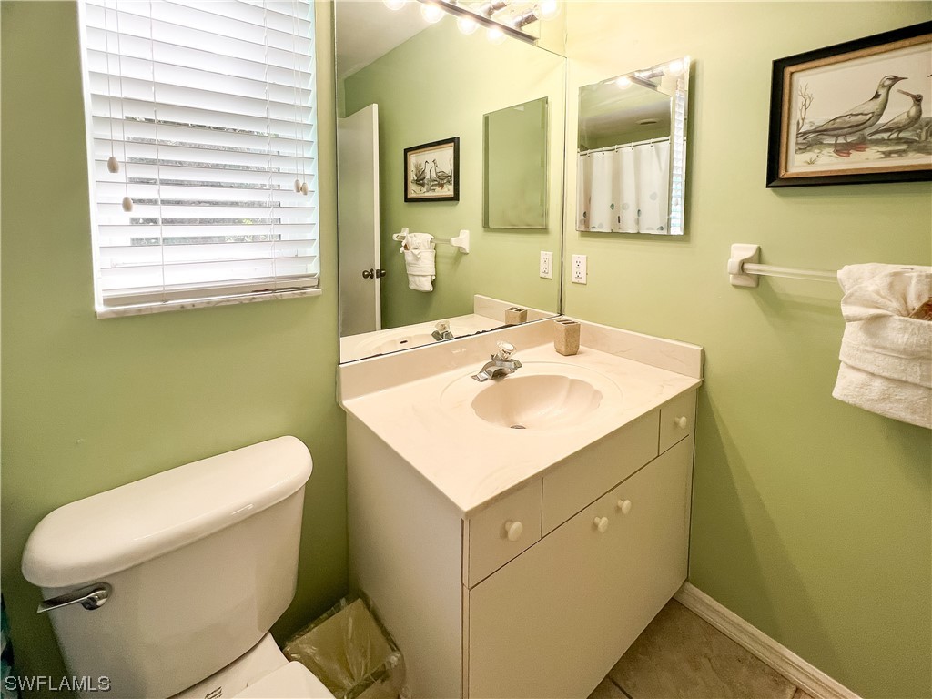 4510 Schooner Drive Upper Captiva, FL 33924 - Photo 40 of 48 a bathroom with a sink toilet and mirror