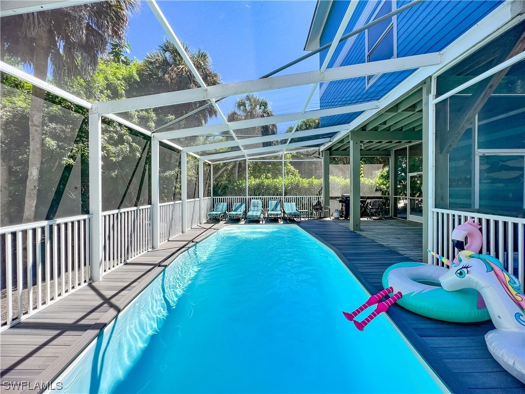 4510 Schooner Drive Upper Captiva, FL 33924 - Photo 46 of 48 a view of a patio with table and chairs potted plants with wooden floor