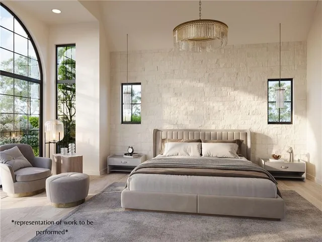 a bedroom with bed a couch and a large window