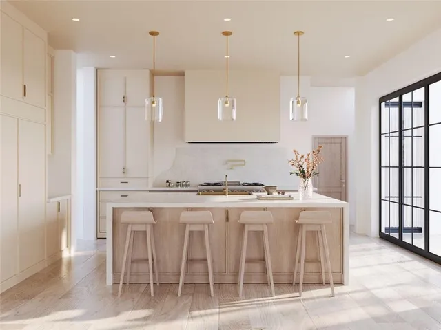 a kitchen with stainless steel appliances granite countertop a stove a sink and a refrigerator