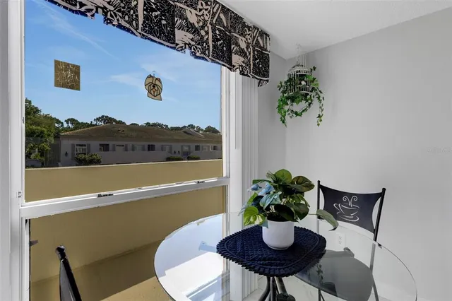 a kitchen with a refrigerator and white cabinets