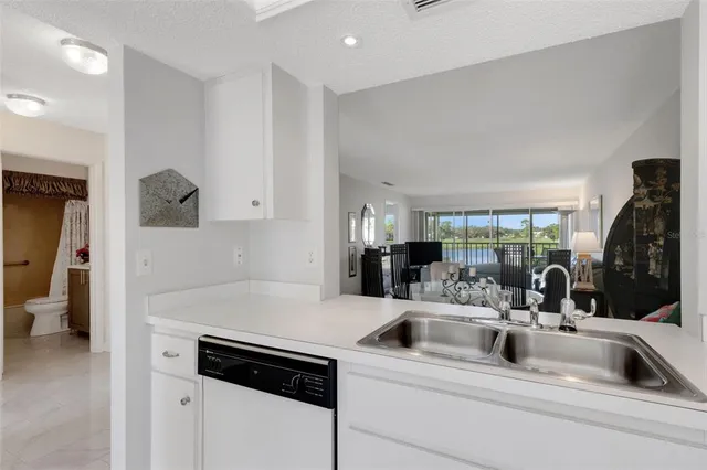 a kitchen with appliances a sink and cabinets