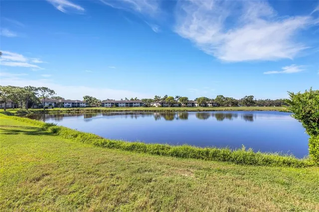 a view of a lake with houses in the back