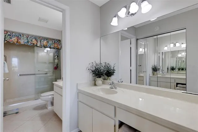 a bedroom with a bed next to a large window with the outer view