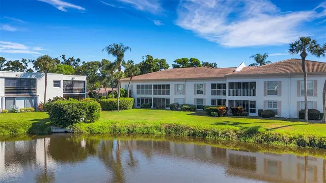 a view of a house with swimming pool and a yard