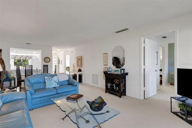 a dining room with furniture water view and a floor to ceiling window