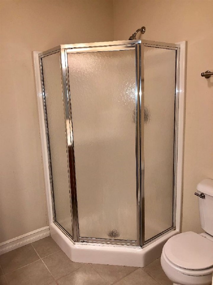 5206 North Woodburn Road Byron, IL 61010 - Photo 11 of 25 a bathroom with a glass shower door