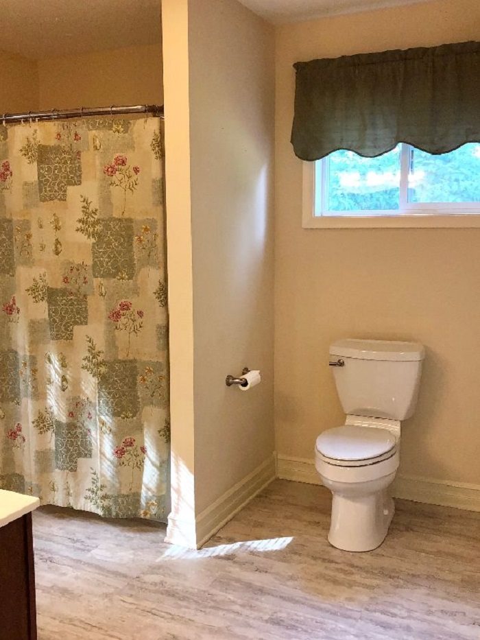 5206 North Woodburn Road Byron, IL 61010 - Photo 14 of 25 a bathroom with a toilet and a shower curtain