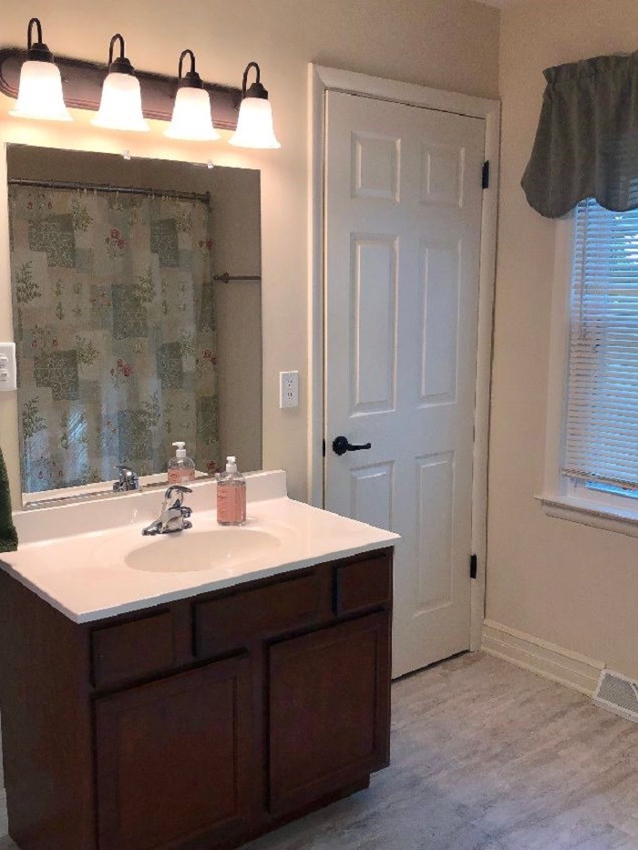 5206 North Woodburn Road Byron, IL 61010 - Photo 15 of 25 a bathroom with a sink and a mirror