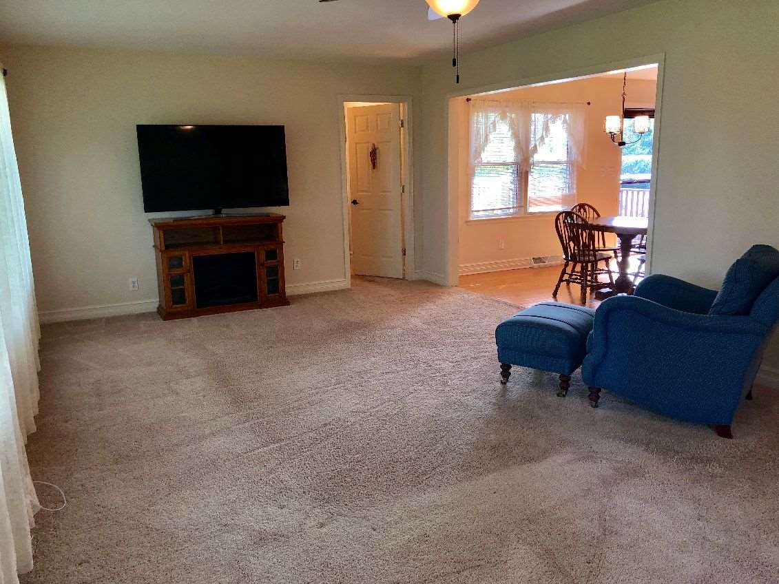 5206 North Woodburn Road Byron, IL 61010 - Photo 2 of 25 a living room with furniture and a flat screen tv