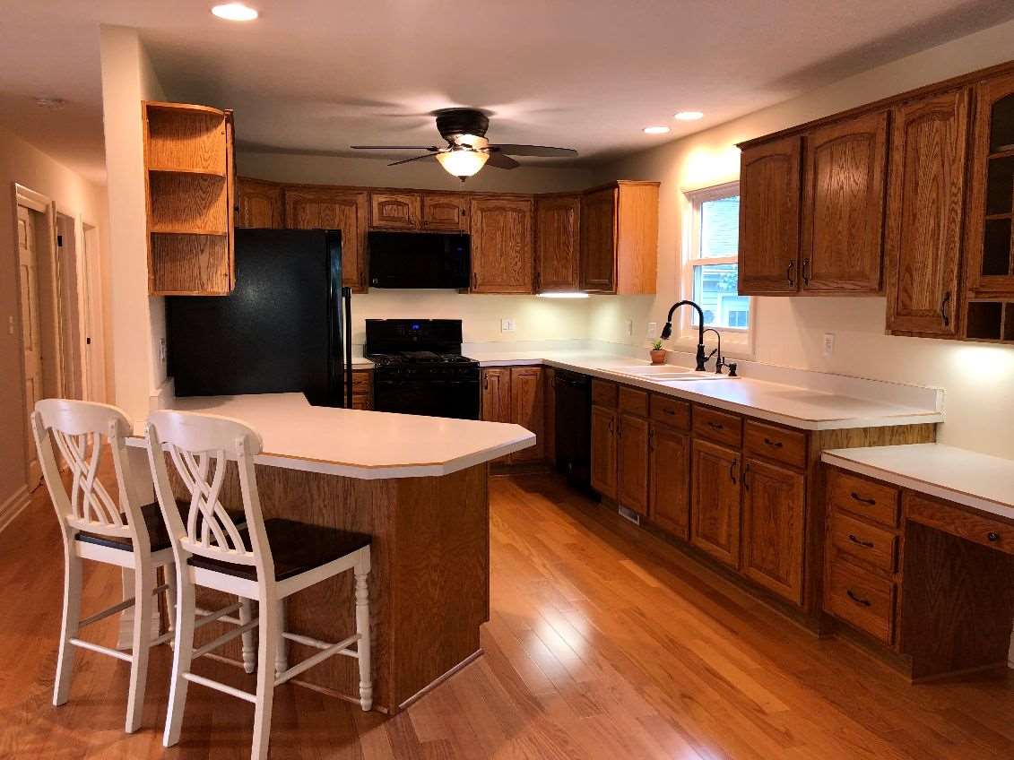 5206 North Woodburn Road Byron, IL 61010 - Photo 4 of 25 a kitchen with stainless steel appliances kitchen island granite countertop a sink a stove a refrigerator cabinets and chairs