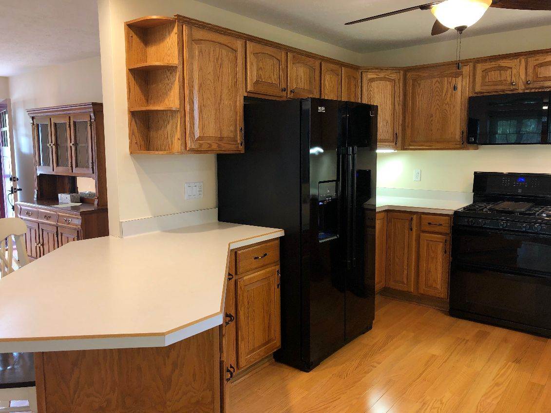 5206 North Woodburn Road Byron, IL 61010 - Photo 6 of 25 a kitchen with a refrigerator and a stove top oven