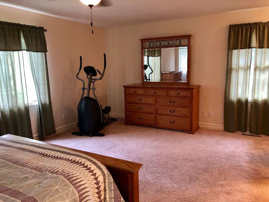 5206 North Woodburn Road Byron, IL 61010 - Photo 9 of 25 a bed room with a bed and a mirror