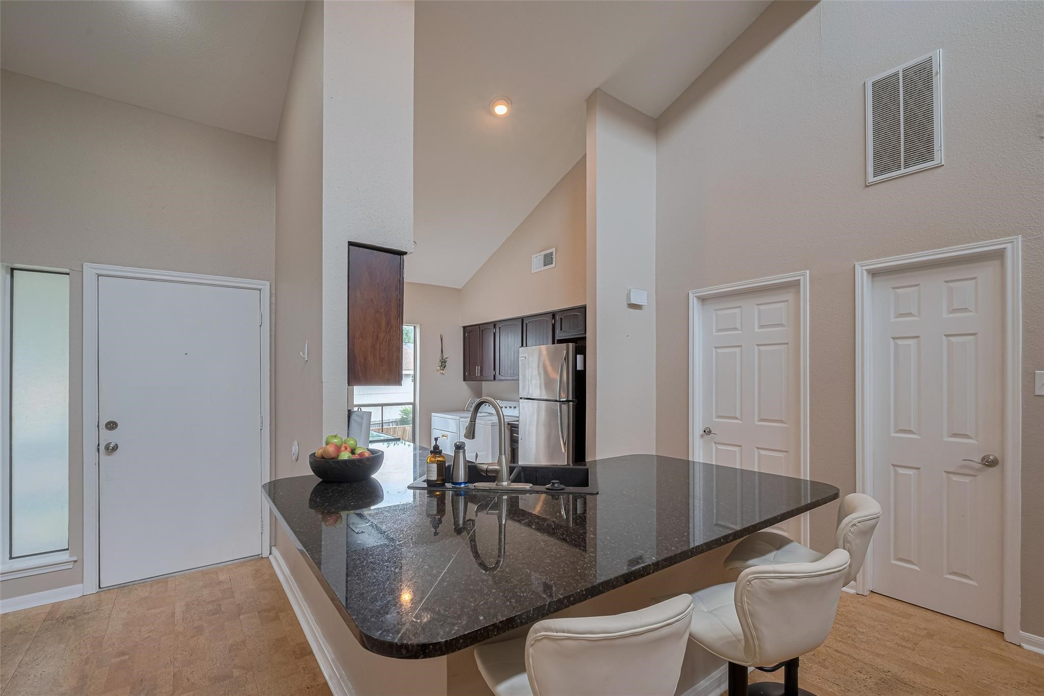 182 April Point Drive North Conroe, TX 77356 - Photo 5 of 18 a kitchen with a table chairs and living room