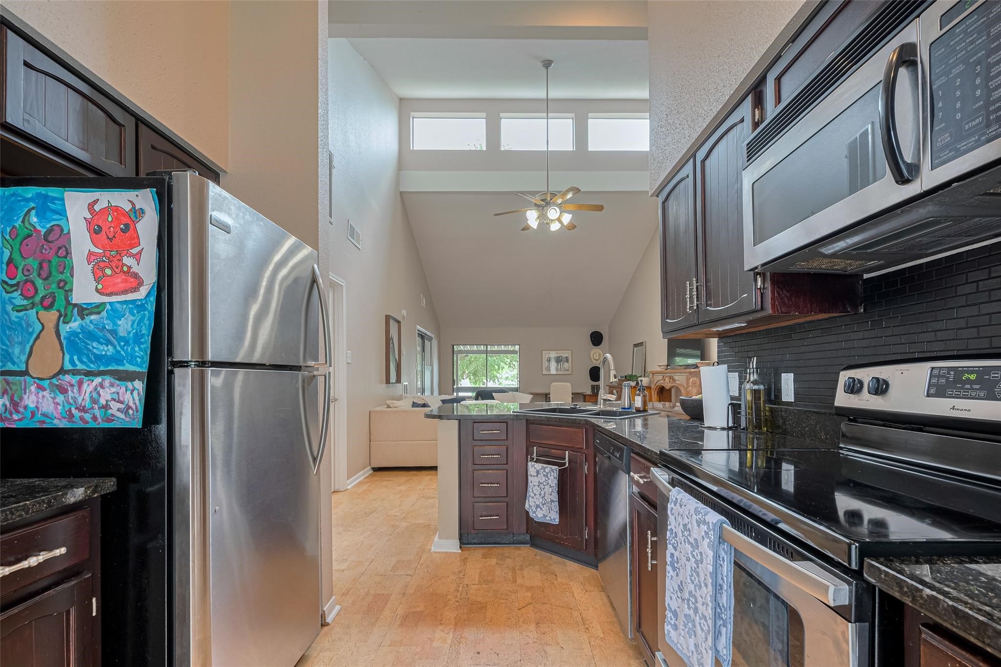 182 April Point Drive North Conroe, TX 77356 - Photo 6 of 18 a kitchen with stainless steel appliances granite countertop a refrigerator and a stove