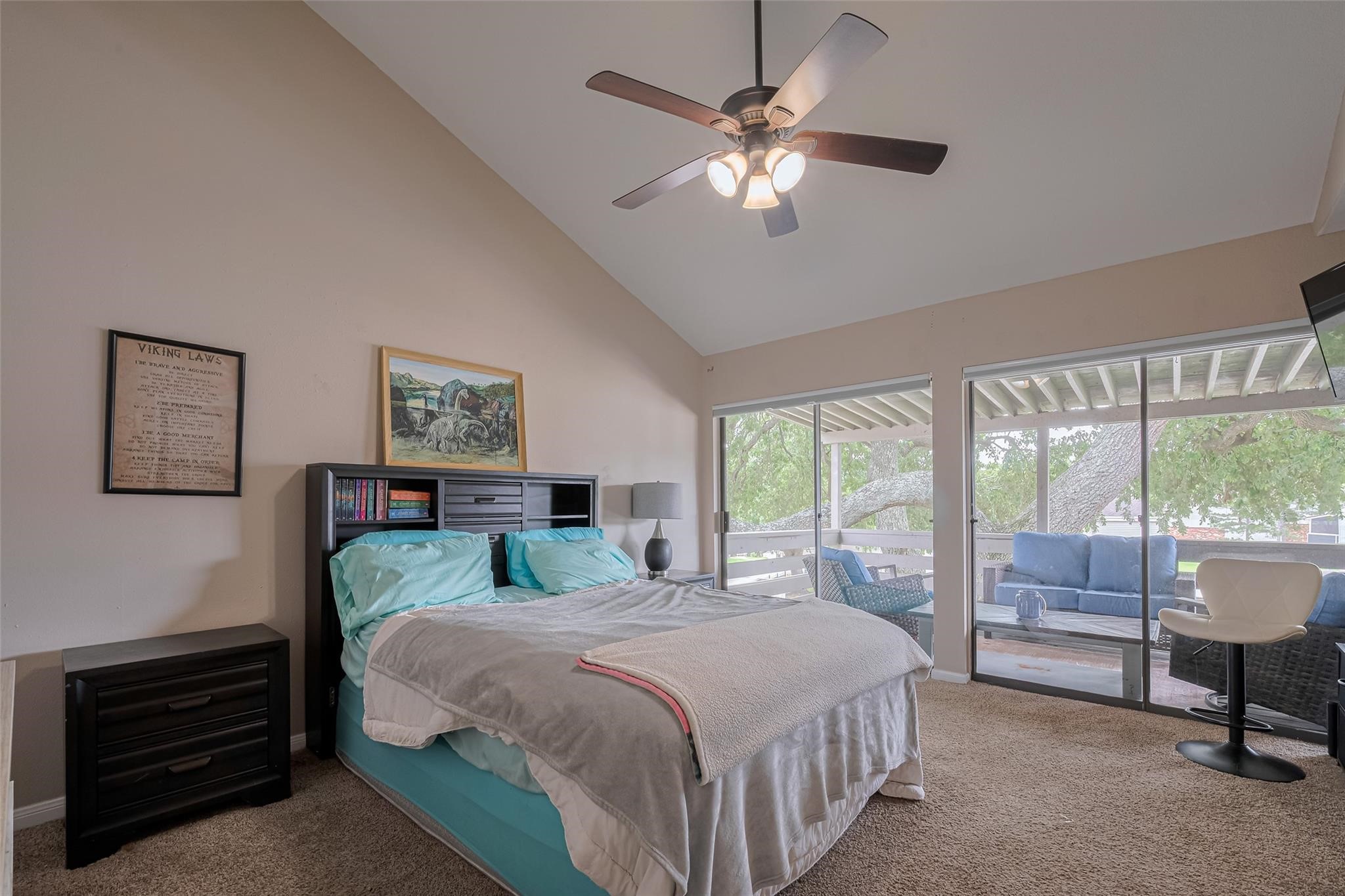 182 April Point Drive North Conroe, TX 77356 - Photo 10 of 18 a bedroom with a large bed and a chandelier